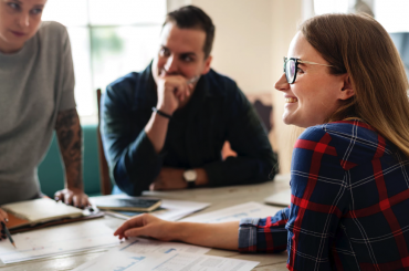 Young woman at desk with plans